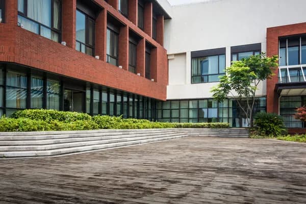 Modern brick residential building with a landscaped courtyard